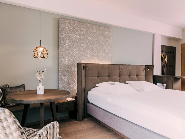 Dog-friendly hotel room at Hotel Schwaigerhof in Schladming, featuring modern furnishings for a relaxing holiday with your dog